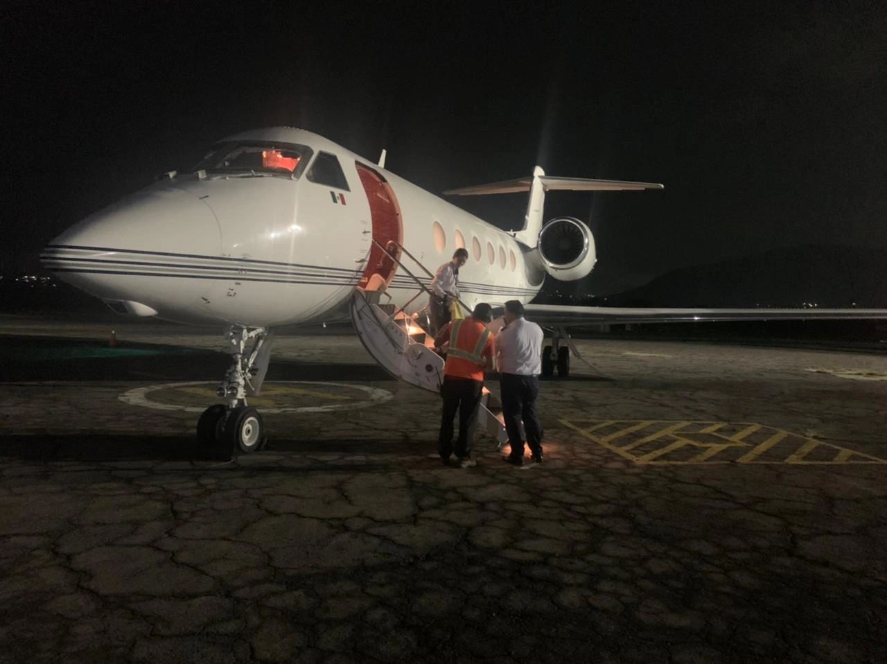 Private jet at night with crew