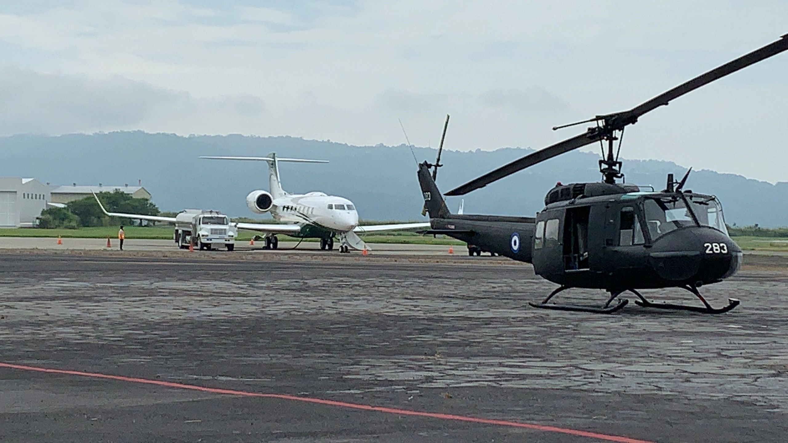 Aircraft on tarmac with helicopter